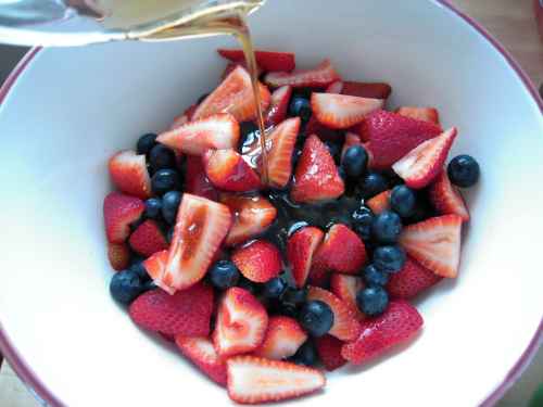 toss berries in maple syrup