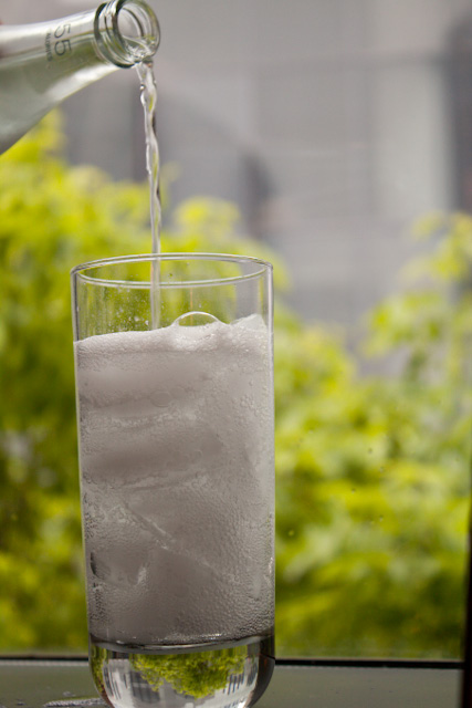 pouring soda into a glass